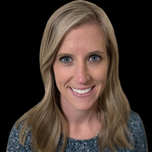 Nicole Callison Smiling person with long blond hair gently curled wearing a speckled gray top